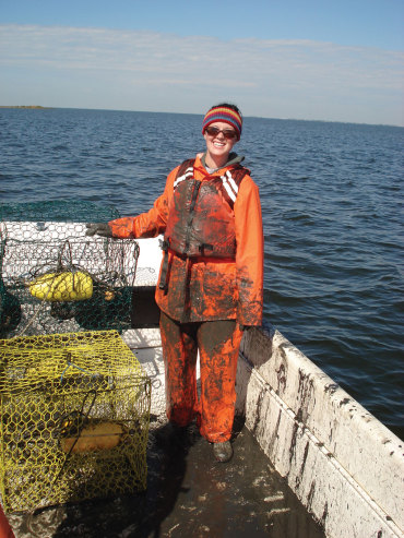 Anna Coffey M.S. '11  shows the direty work involved in pulling crab pots.