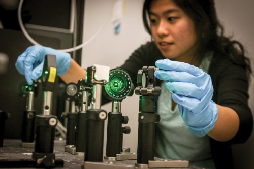 MIRROR MIRROR: Jenna Tan ’16 adjusts mirrors to align a green laser for spectroscopy studies in Wustholz’s lab.