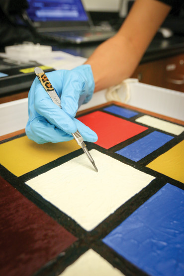 Joo Yeon Roh ’16 demonstrates how students remove samples using a mock artwork.