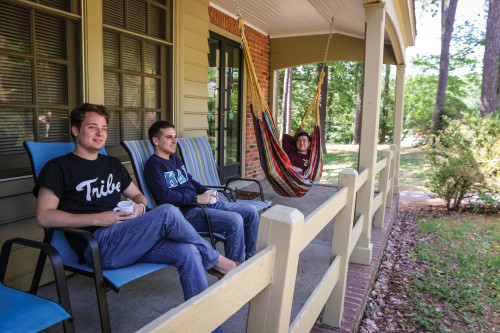 LODGE LAYOUT: Students enjoying the back porch of a Lodge