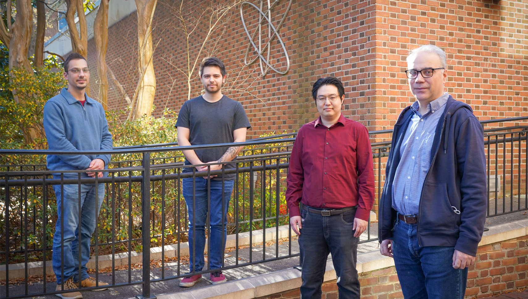 Graduate students (from left) Joseph Cuozzo, Trey Anderson and Jaeyeong Lee work with Rossi.