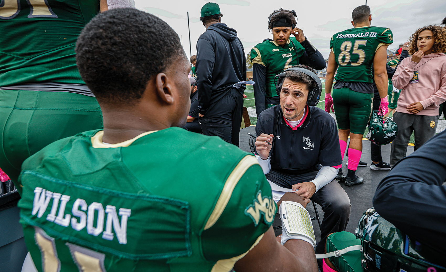 Christian Taylor '07 coaching a player on the W&M sideline