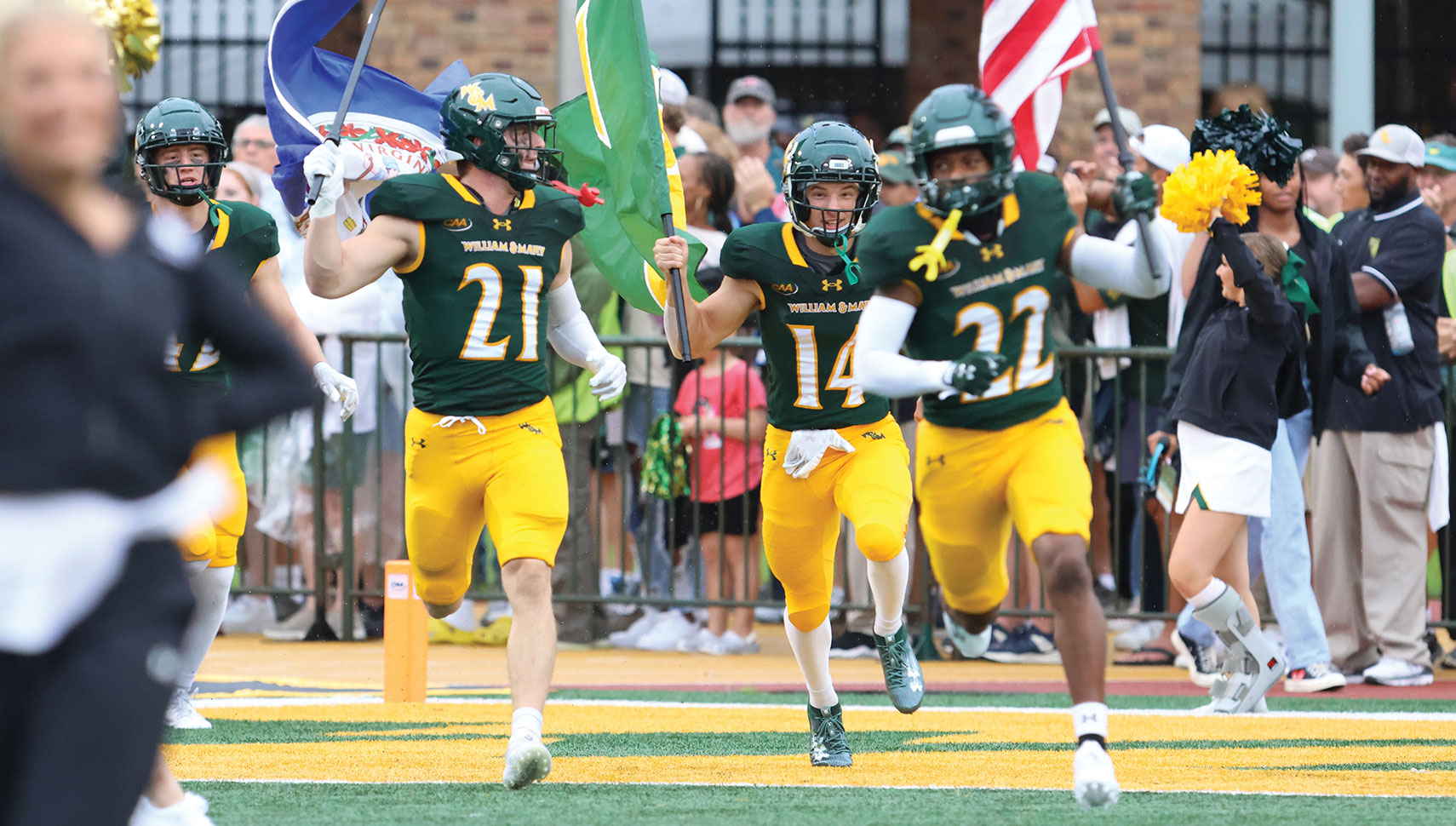 football players running onto the field