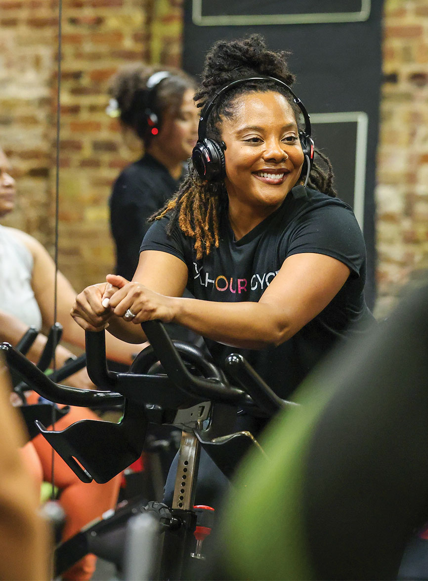 Jennifer Gray Braswell smiling while sitting on a cycle