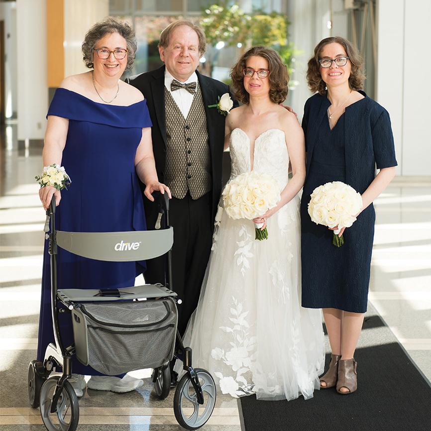 family dressed for a wedding and posing for a photo