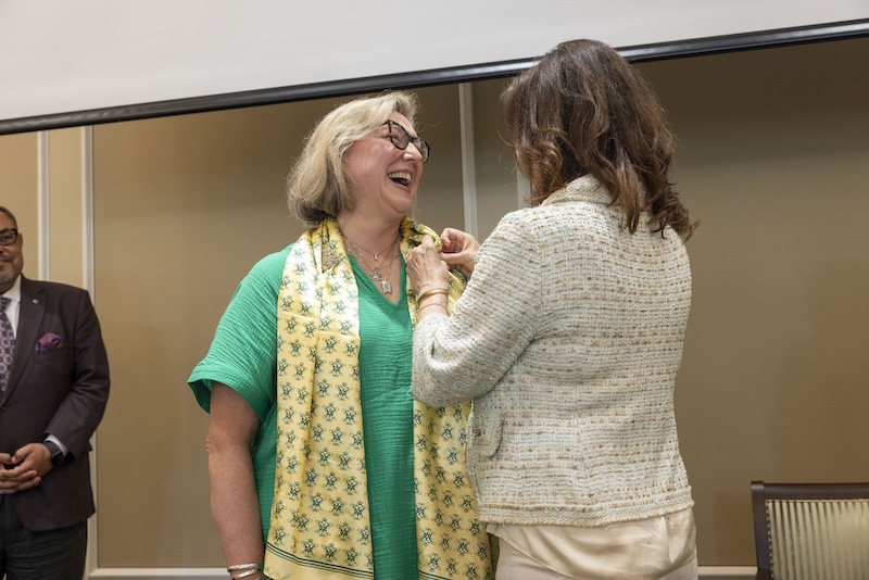 Woman laughing with other woman in the photo.