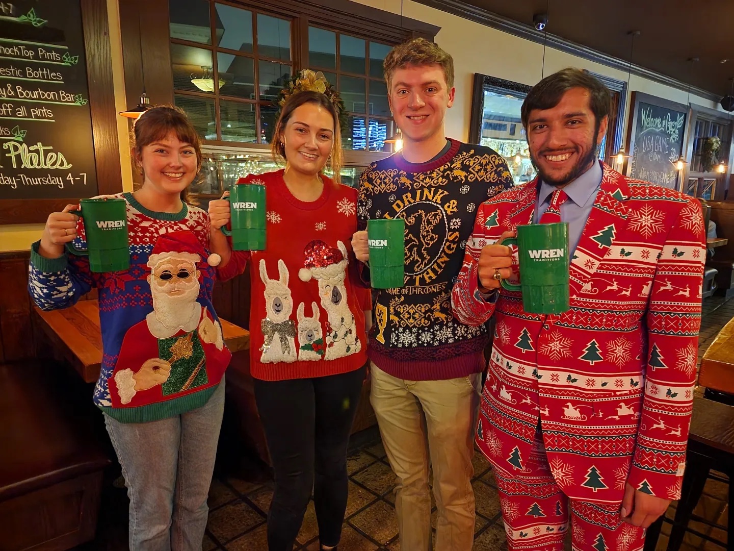 Members of the Class of 2023 with their Senior Class Gift mugs and wearing holiday clothes