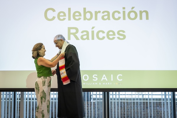 Photo of a woman giving a stole to a man