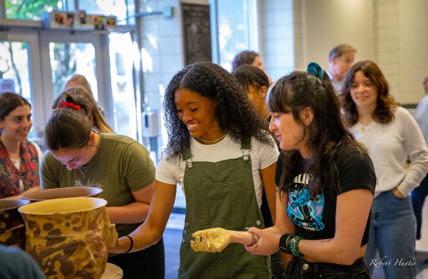 Students adding handprints to the artwork at the April event