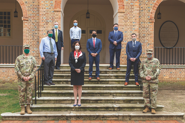 President Rowe stands with members of the William & Mary veteran and active-duty military community