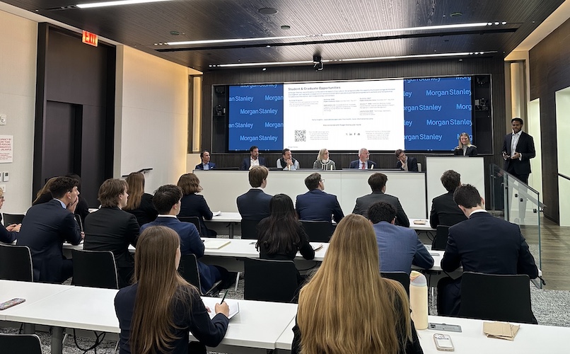 Students sit in on a meeting at Moran Stanley.