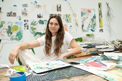 Woman at a table with art